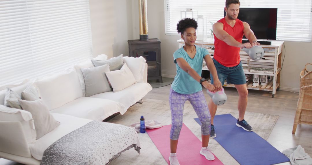 Couple Exercising Together with Kettlebells at Home