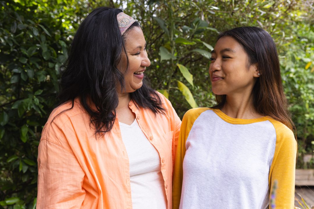 Happy Mother and Daughter Smiling in Backyard