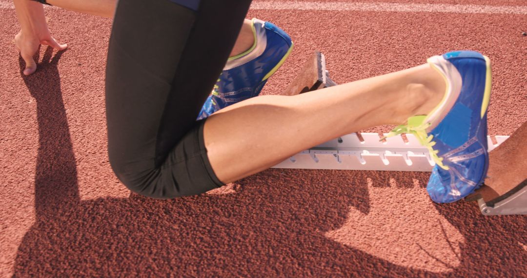 Athlete preparing in starting block on track - Free Images, Stock Photos and Pictures on Pikwizard.com