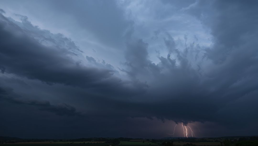 Spectacular Lightning Storm Over Darkened Fields at Dusk