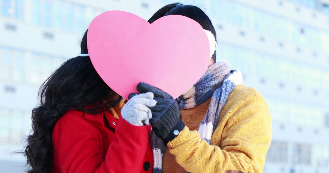 Couple Holding Heart Shape During Winter Embracing Romance - Free Images, Stock Photos and Pictures on Pikwizard.com