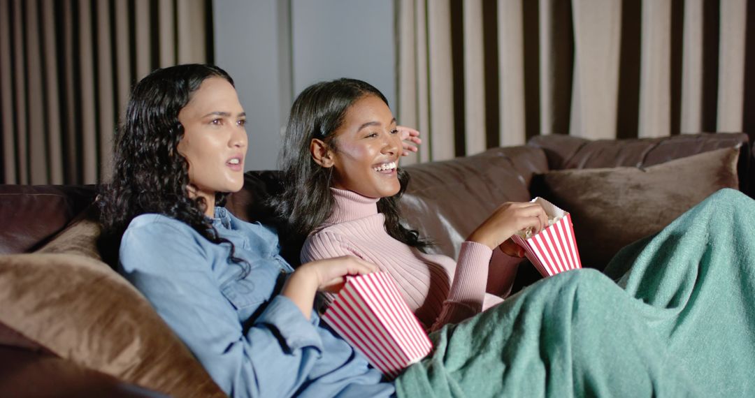 Friends Relaxing Watching TV on Sofa with Popcorn at Home