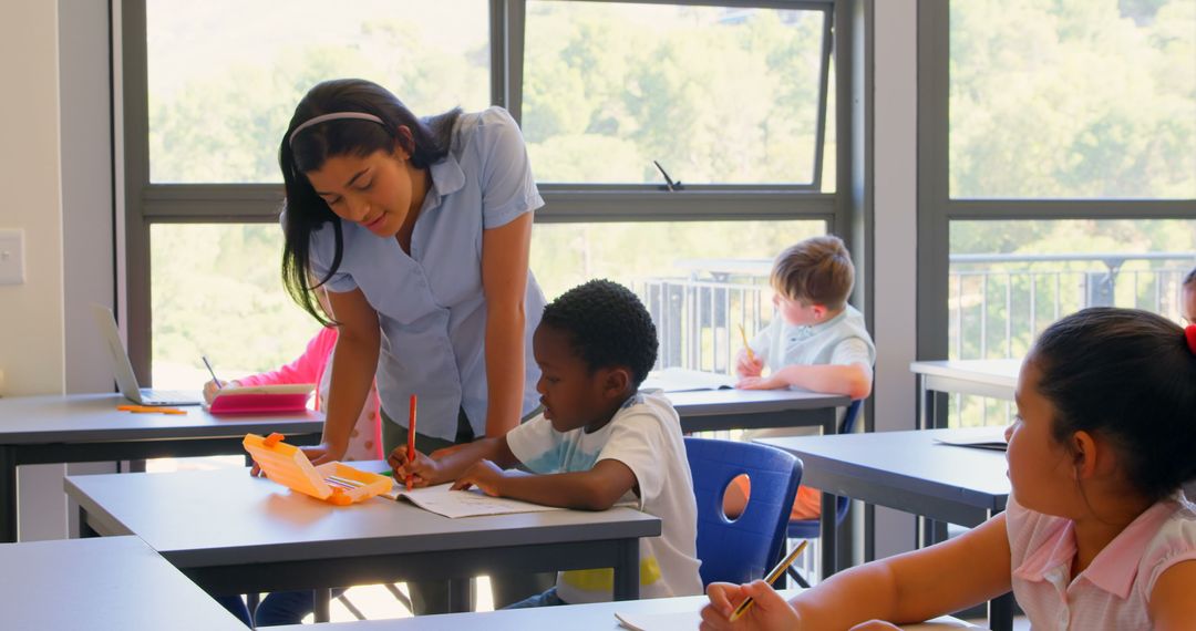Teacher Assisting Student with Classwork in Bright Classroom