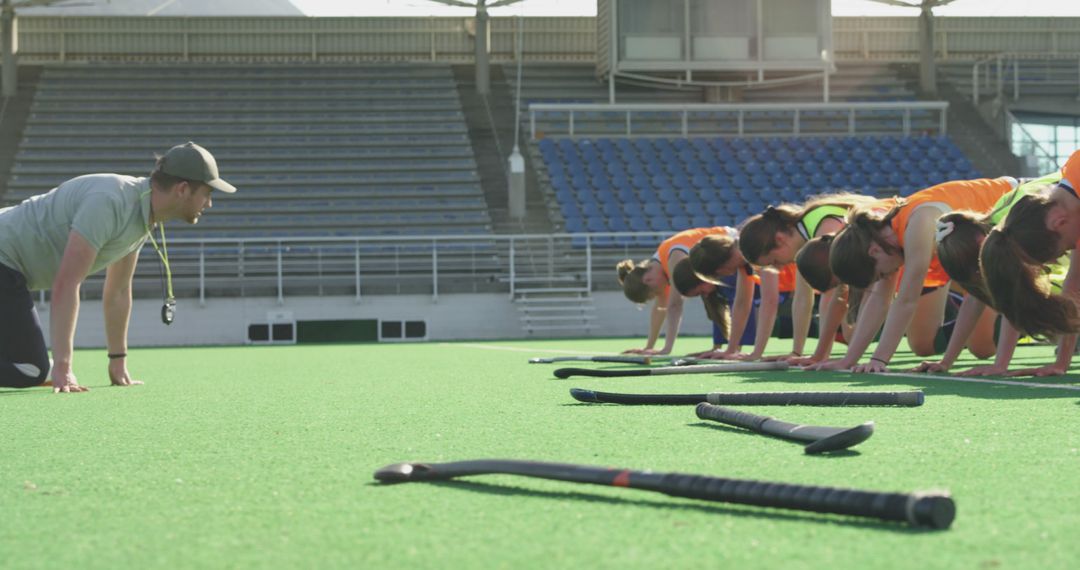 Field Hockey Coach Training Female Team on Turf Field - Free Images, Stock Photos and Pictures on Pikwizard.com