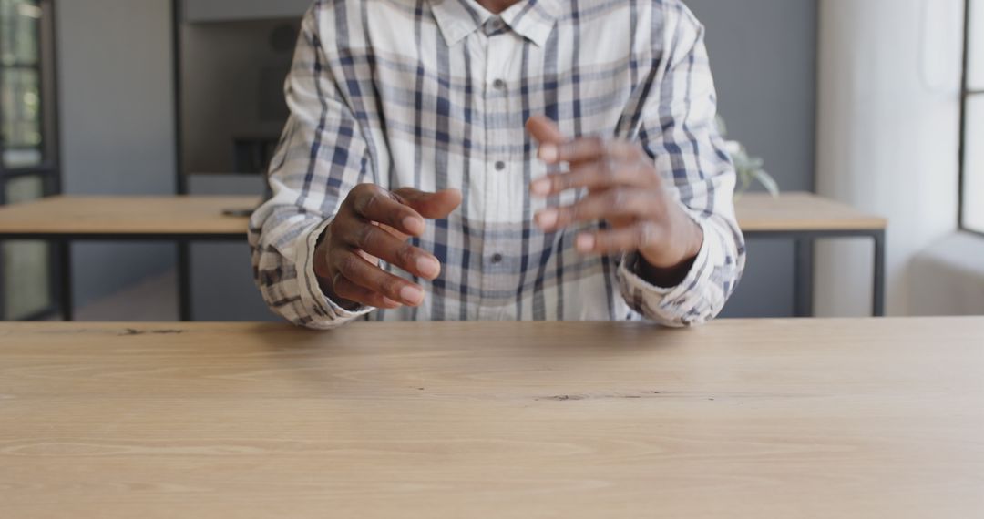 Business Professional Discussing Strategy With Hand Gestures at Office Desk
