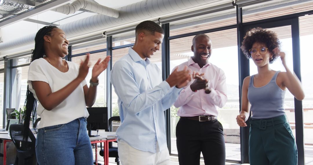 Happy Colleagues Applauding Success in Modern Office Space