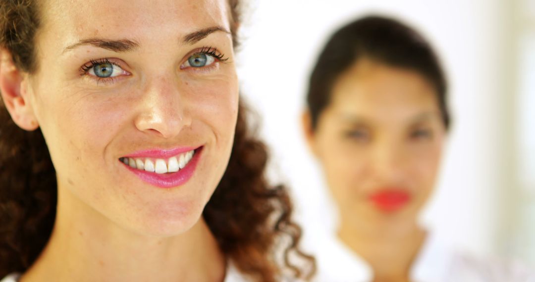 Closeup of Smiling Woman with Friend in Background - Free Images, Stock Photos and Pictures on Pikwizard.com