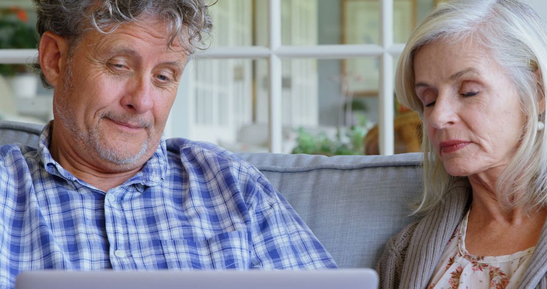 Content Senior Couple Using Laptop Together at Home