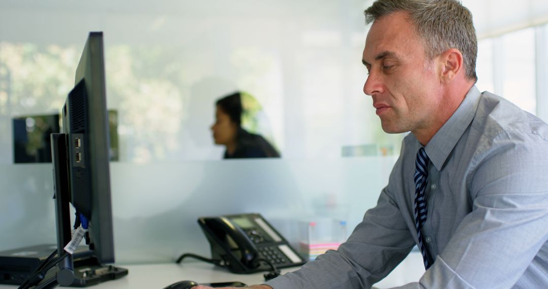 Focused businessman working at corporate office desk