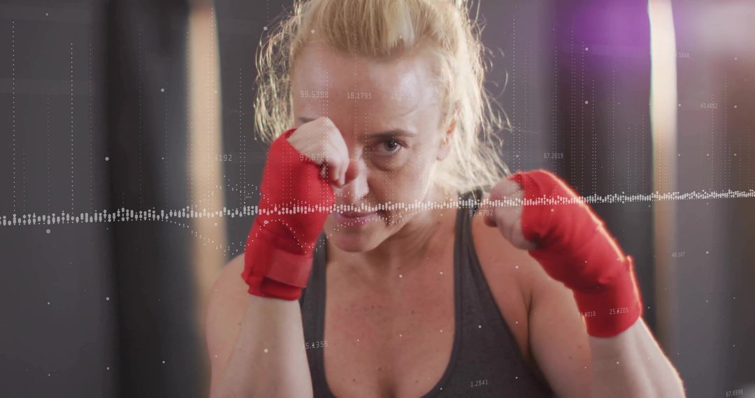 Fit Woman Boxing with Red Wraps and Waveform Overlay in Gym