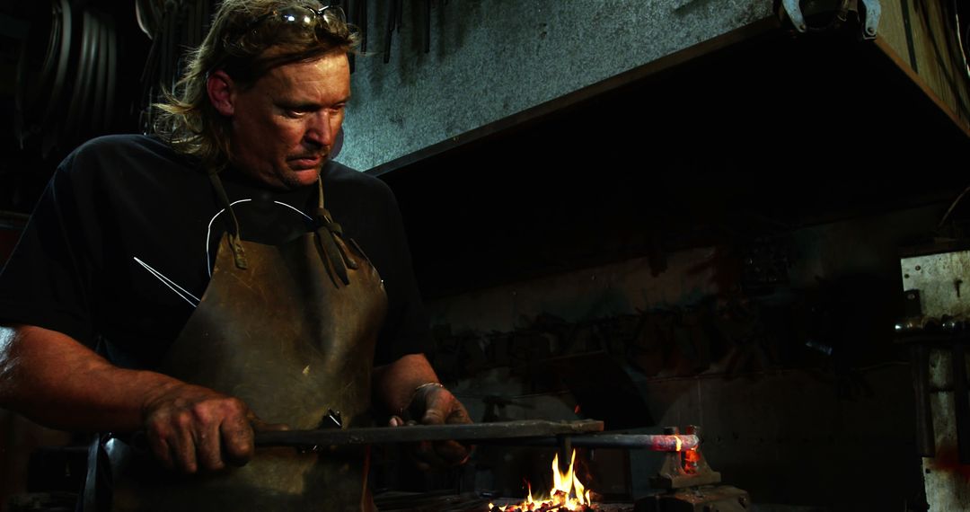 Experienced Blacksmith Skillfully Crafting in Workshop