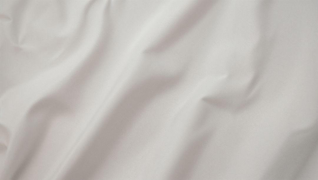 White Fabric with Soft Folds and Shadows Highlighting Texture