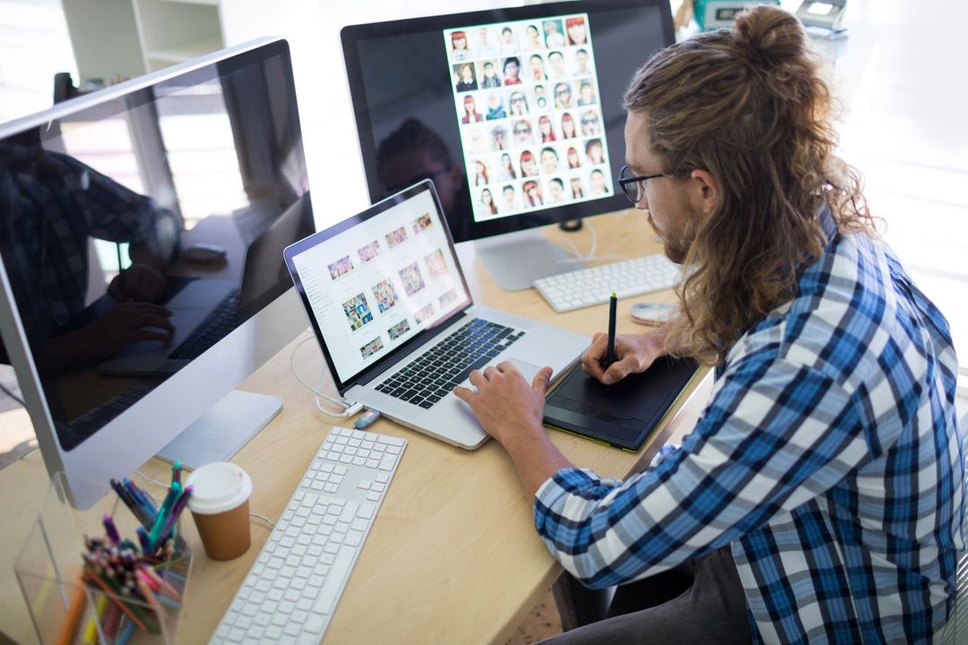 Graphic Designer Working on Creative Art Projects in Modern Office