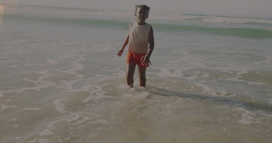Young Girl Enjoying Ocean Waves on Breezy Beach Day