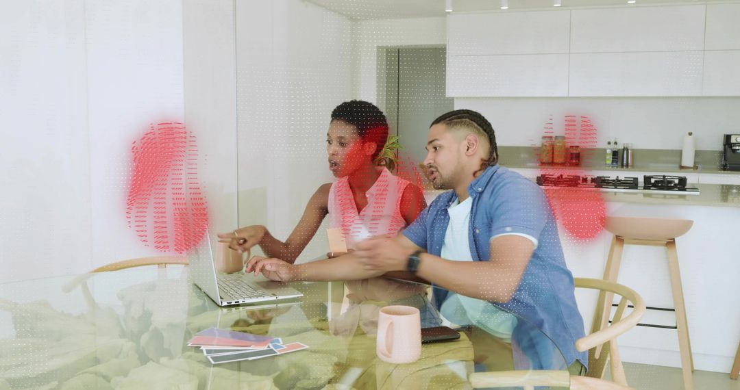 Couple Collaborating on Home Design Using Laptop and Fabric Swatches in Modern Kitchen