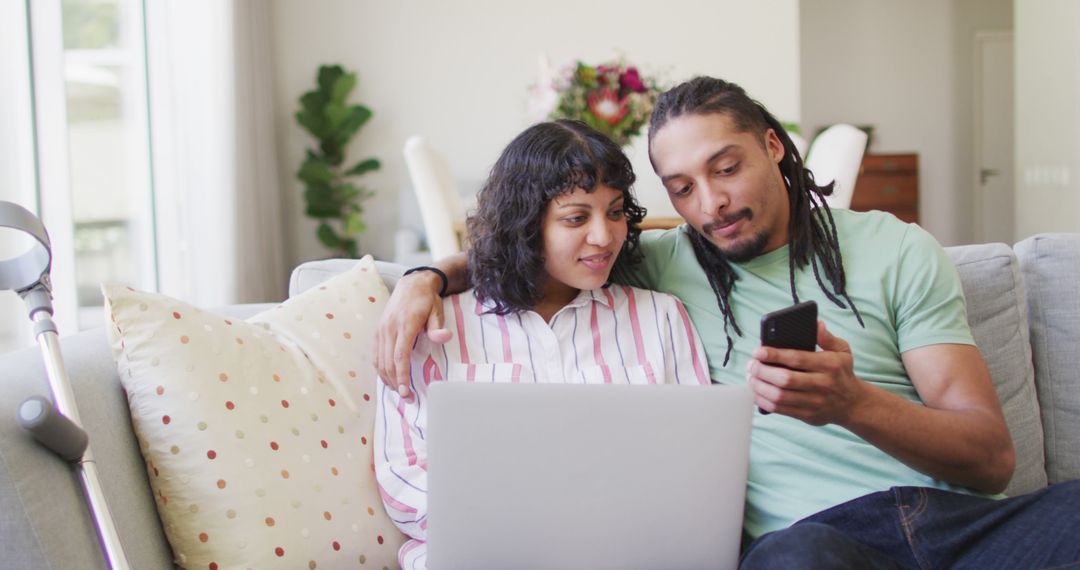 Biracial Couple at Home Using Technology for Relaxed Break