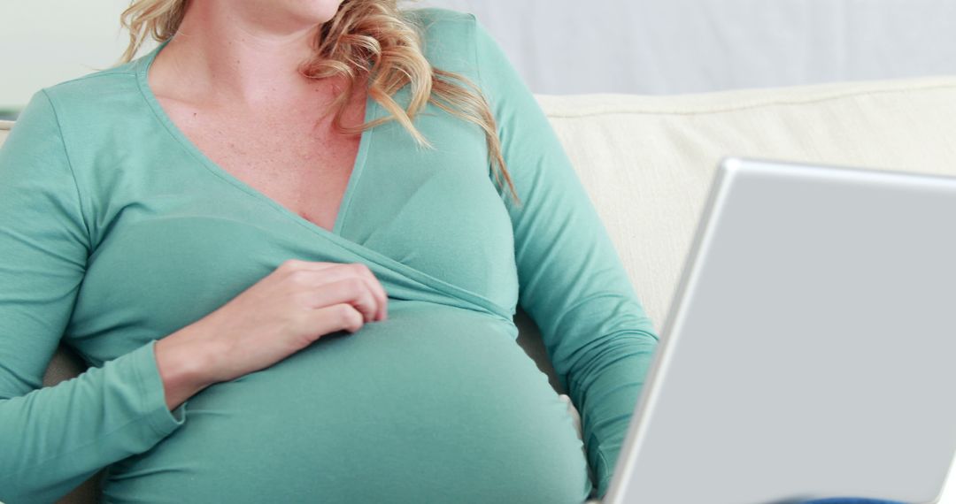 Pregnant Woman Using Laptop on Couch at Home - Free Images, Stock Photos and Pictures on Pikwizard.com