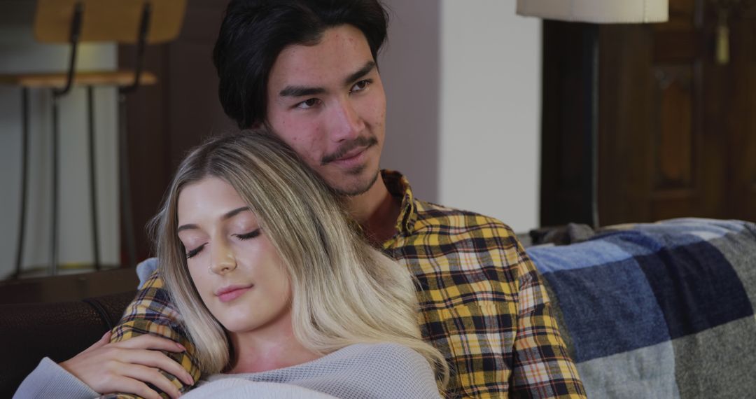 Couple Embracing Affectionately on Couch at Home