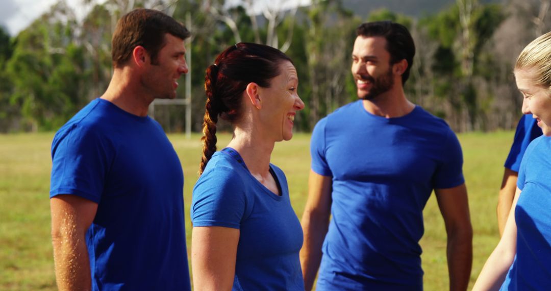 Group of Adults Engaging in Outdoor Team Activity in Blue Shirts - Free Images, Stock Photos and Pictures on Pikwizard.com