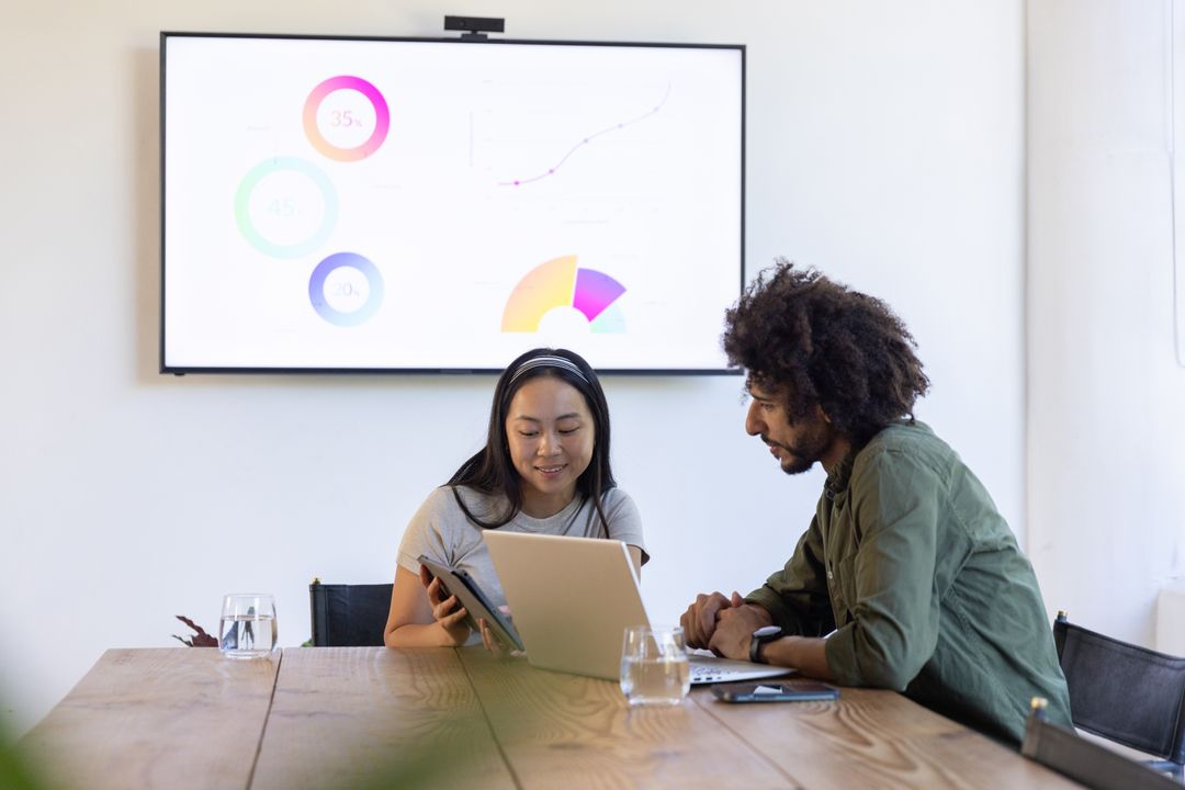Diverse Team Collaborating in Meeting Room with Digital Technology