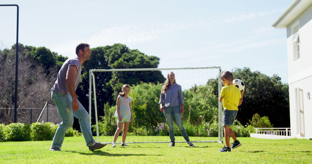 Happy Family Playing Soccer in Backyard on a Sunny Day - Free Images, Stock Photos and Pictures on Pikwizard.com