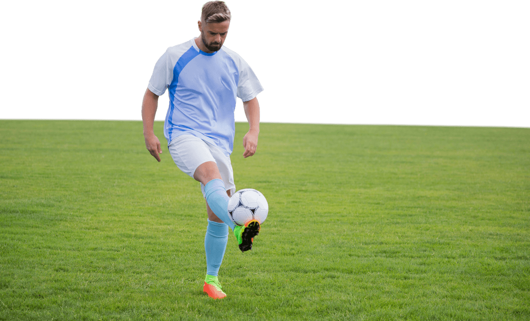 Man Practicing Kicking Soccer Ball on Clear Green Field