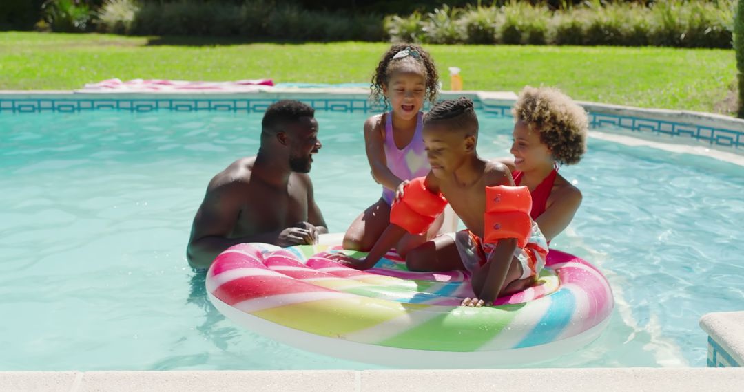 Family Enjoying Sunny Day in Backyard Pool on Rainbow Inflatable