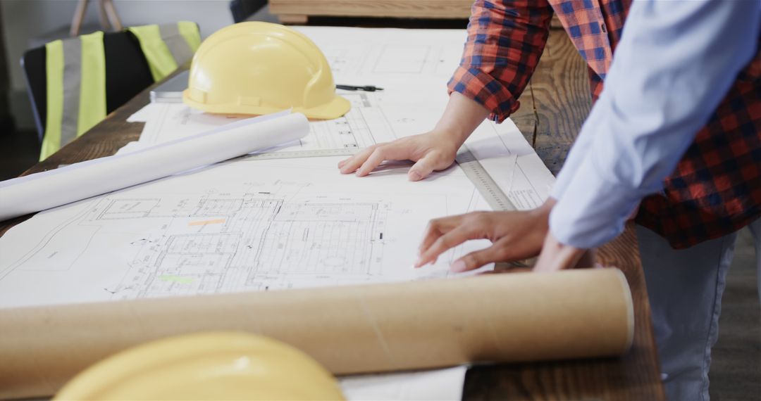 Team Working on Construction Blueprints at Meeting Table - Free Images, Stock Photos and Pictures on Pikwizard.com