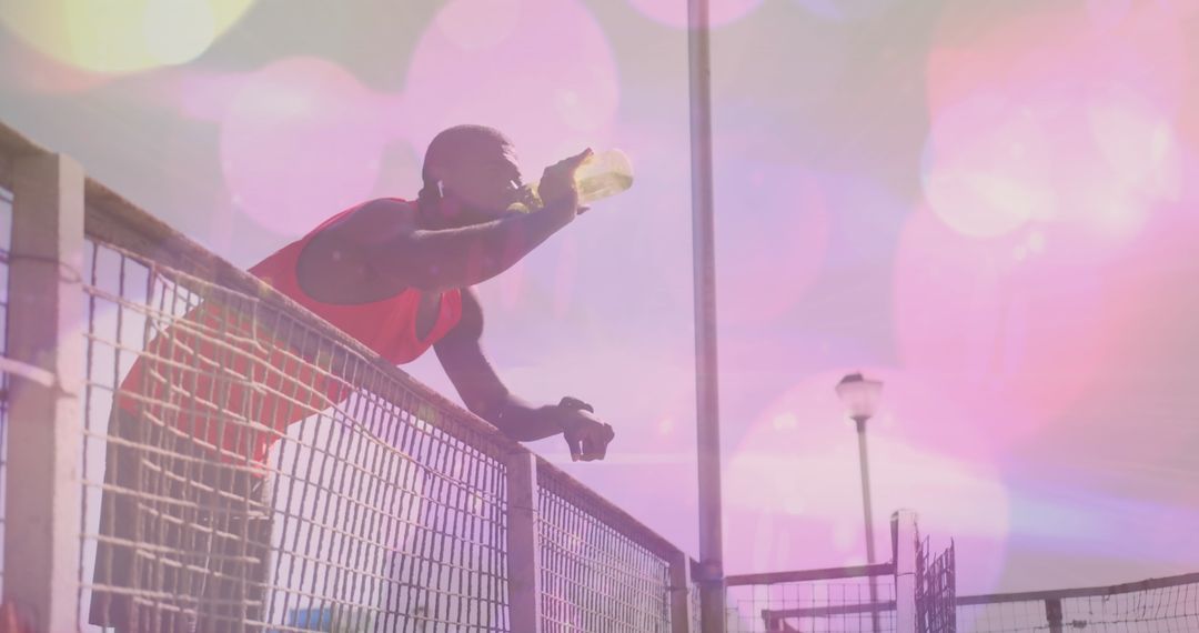 Athletic Man Hydrating at Beach with Light Filters