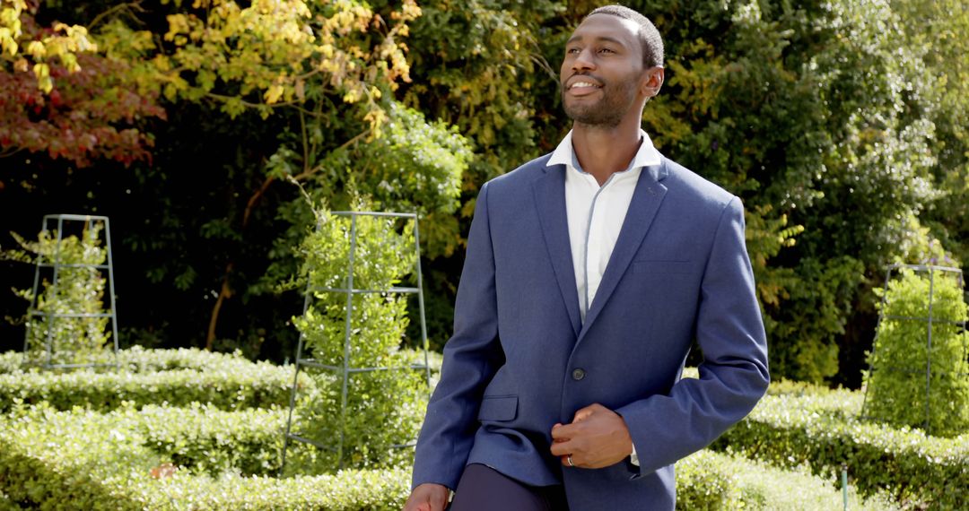 Happy african american groom in wedding suit standing in sunny garden - Free Images, Stock Photos and Pictures on Pikwizard.com