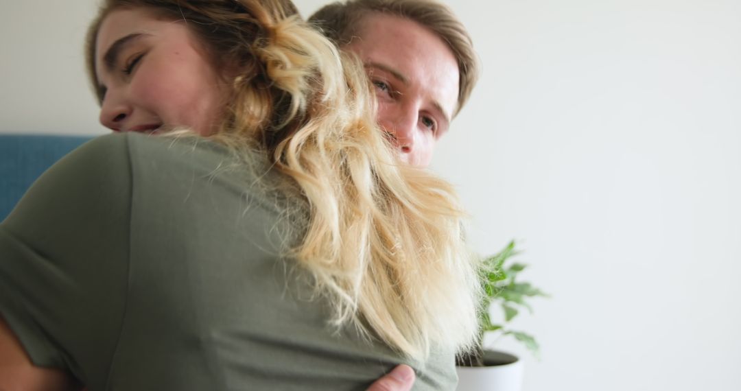 Joyful Couple Embracing with Positive Pregnancy Test