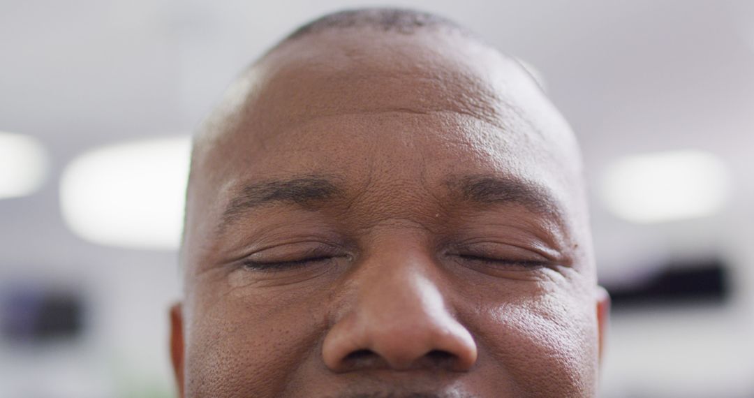Close up of african american businessman with eyes closed at office - Free Images, Stock Photos and Pictures on Pikwizard.com