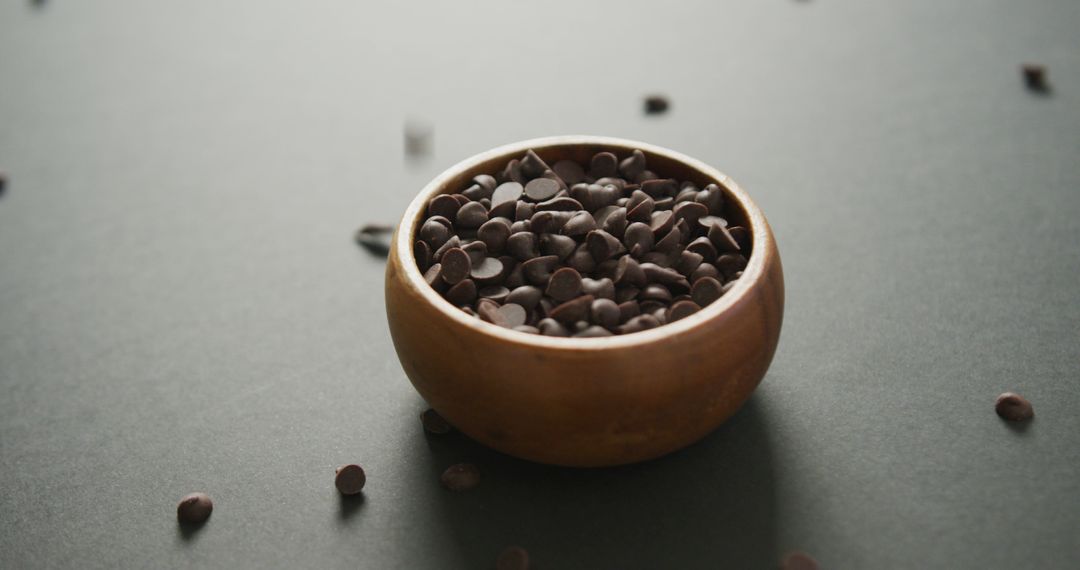 Chocolate Chips in Wooden Bowl on Gray Surface - Free Images, Stock Photos and Pictures on Pikwizard.com