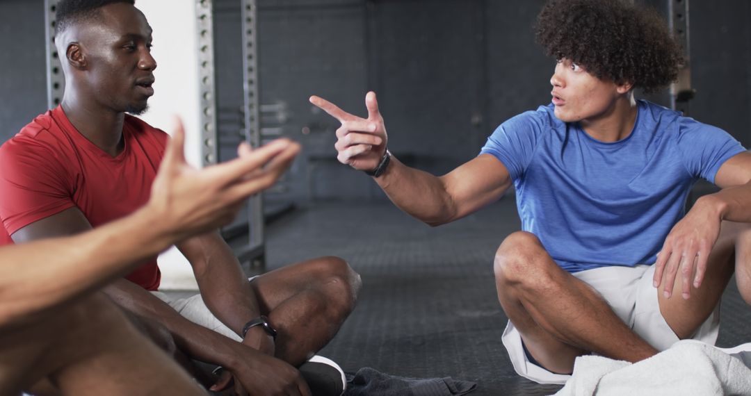 Men Engaged in Active Discussion During Workout Break