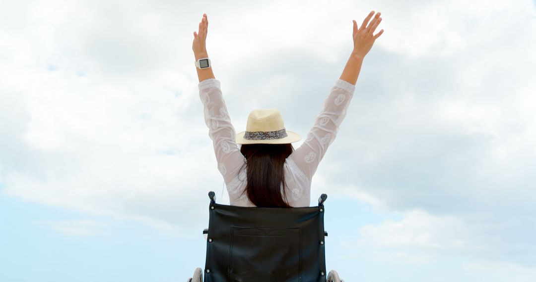 Woman in Wheelchair Enjoying Beach Raising Arms Skyward - Free Images, Stock Photos and Pictures on Pikwizard.com