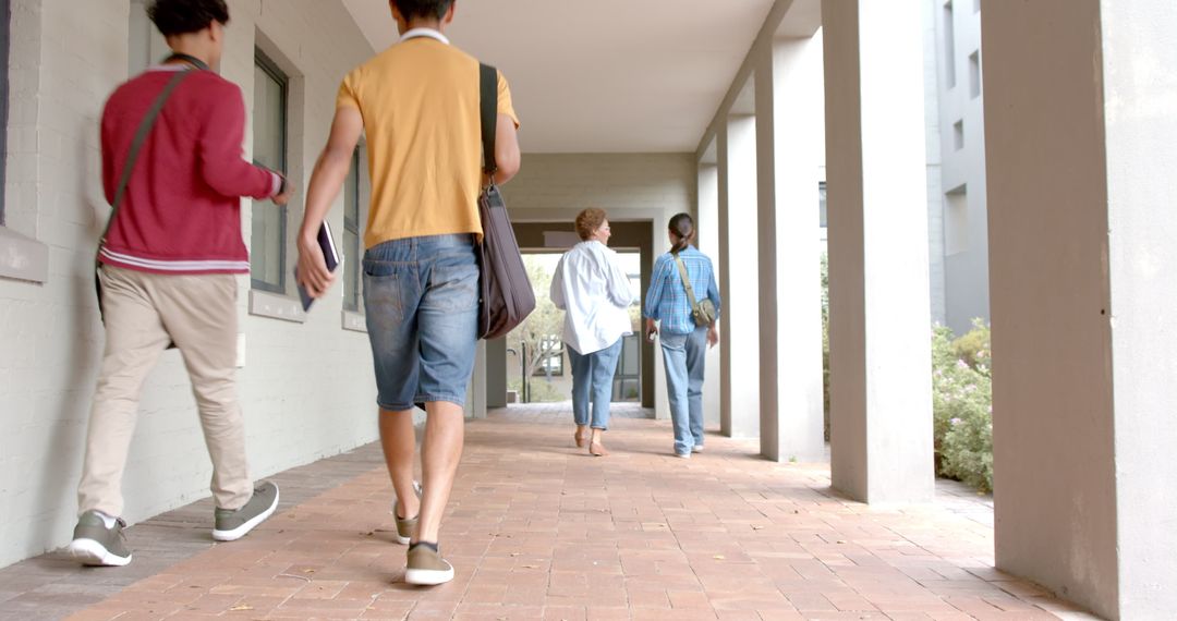 Students Walking in School Hallway with Backpacks and Books