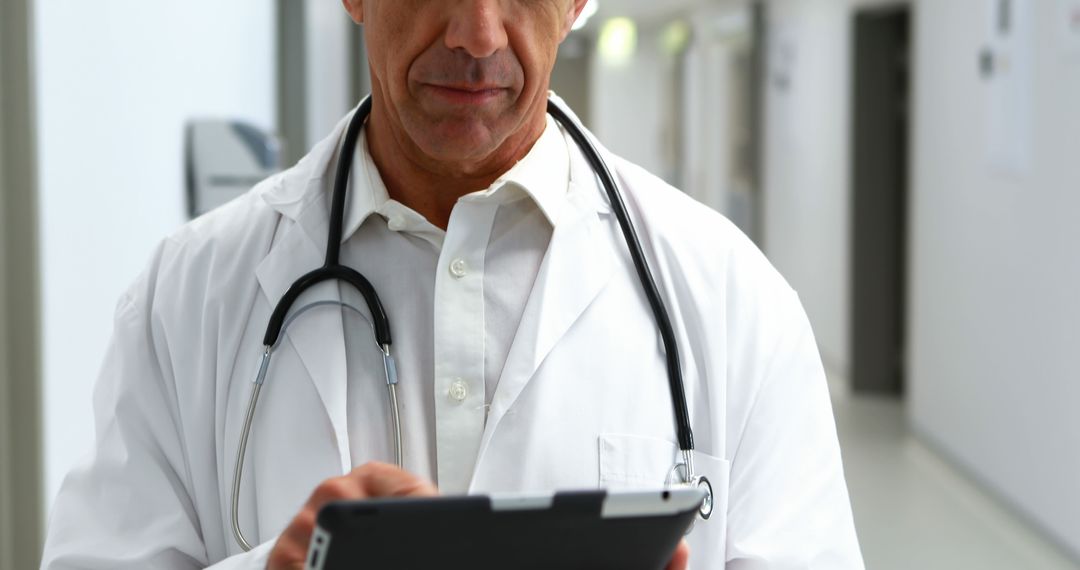 A doctor attentively examines patient data on a tablet, highlighting the value of precise records. - Free Images, Stock Photos and Pictures on Pikwizard.com