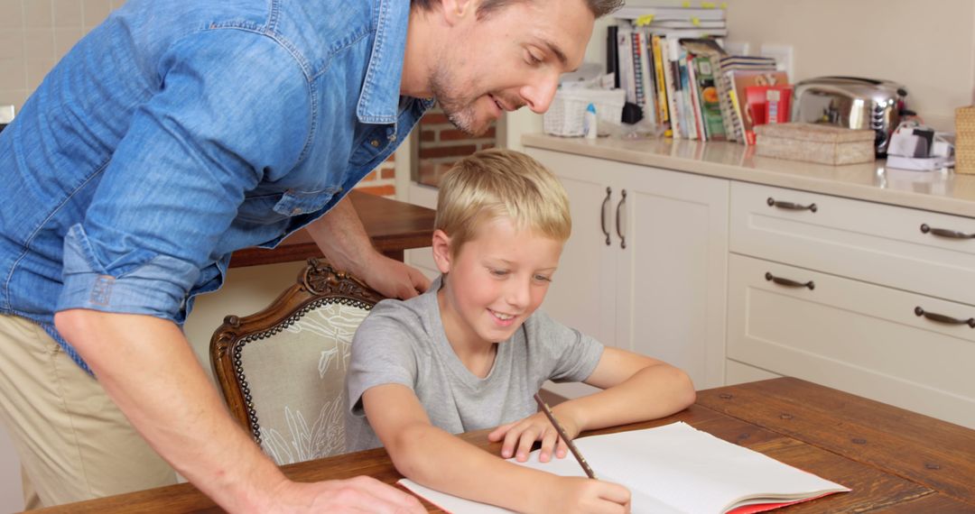 Father Helping Young Son with Homework in Kitchen - Free Images, Stock Photos and Pictures on Pikwizard.com