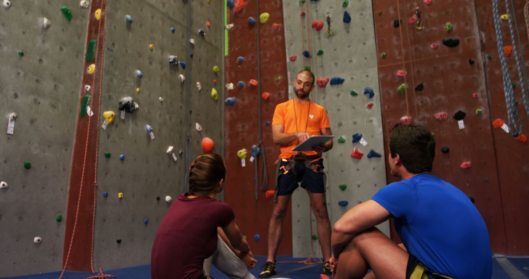 Instructor Teaching Indoor Rock Climbing To Beginners - Free Images, Stock Photos and Pictures on Pikwizard.com