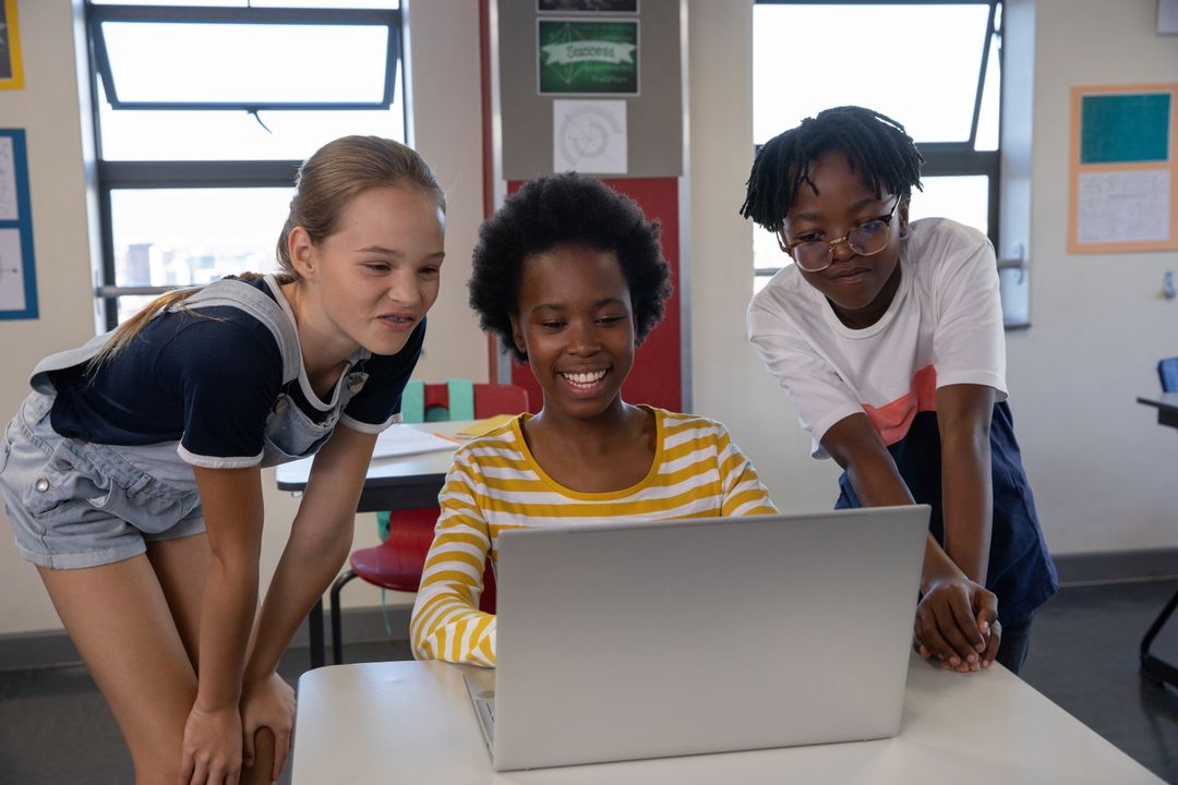 Diverse Students Collaborating on Laptop in Classroom Setting