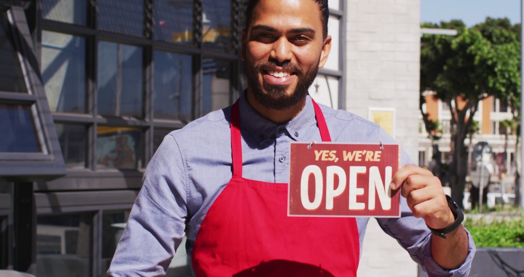 Smiling Barista Holding Open Sign Outside Coffee Shop - Free Images, Stock Photos and Pictures on Pikwizard.com