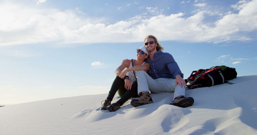 Couple Relaxing on Sandy Dune under Blue Sky - Free Images, Stock Photos and Pictures on Pikwizard.com