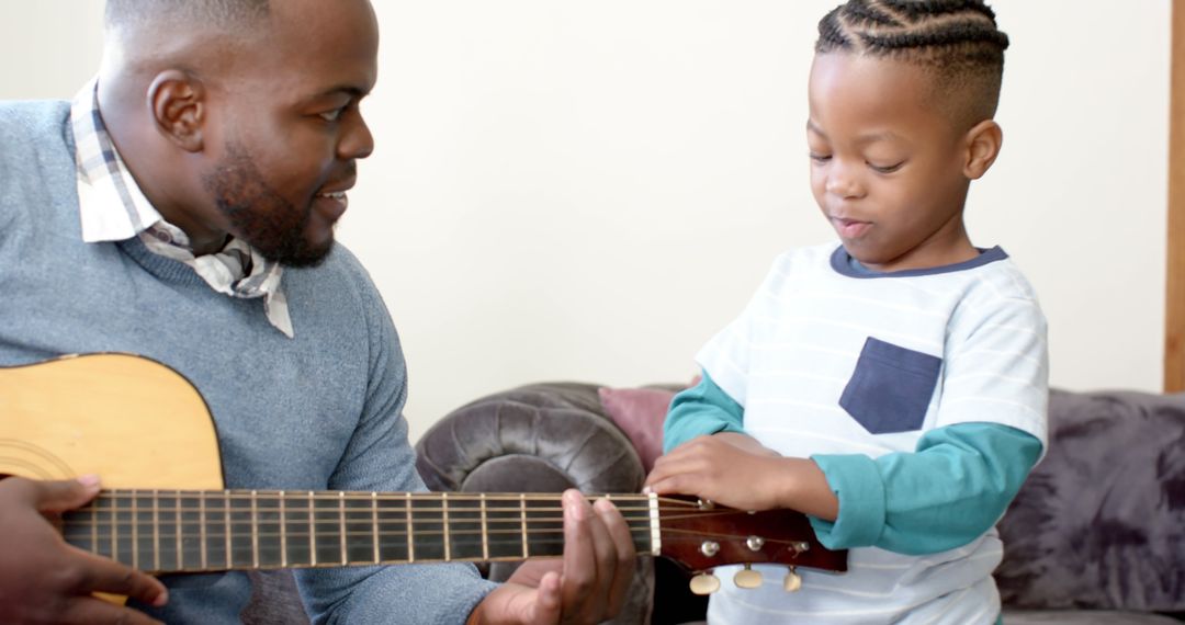 Father Teaching Young Son to Play Acoustic Guitar - Free Images, Stock Photos and Pictures on Pikwizard.com