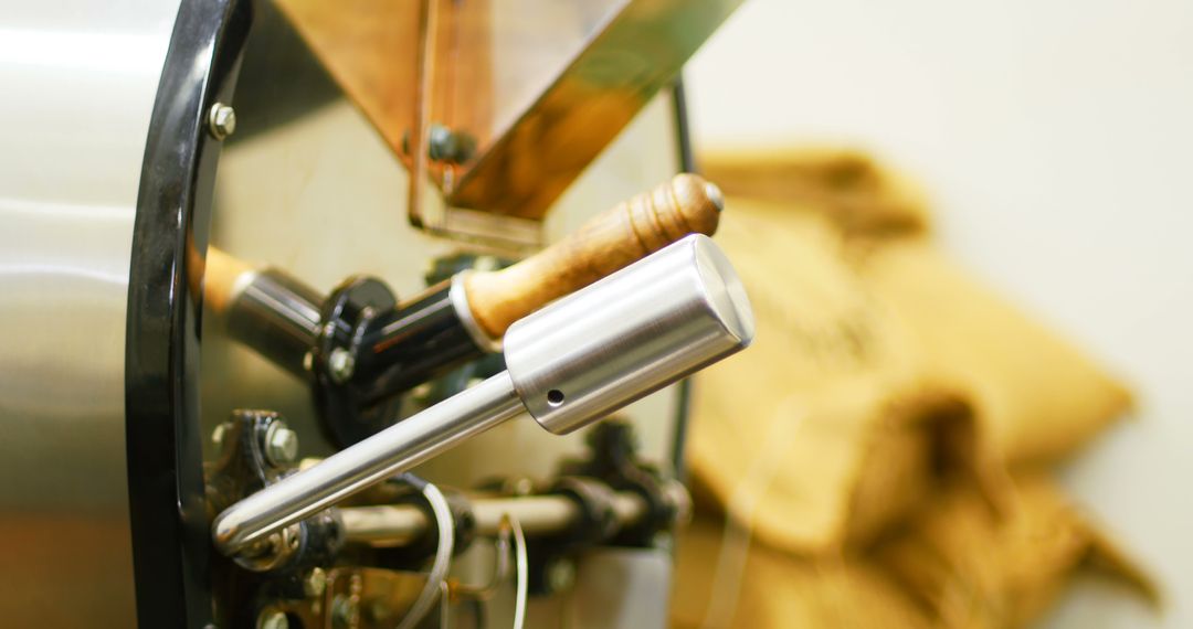 Man Operating Coffee Grinder in Cafeteria