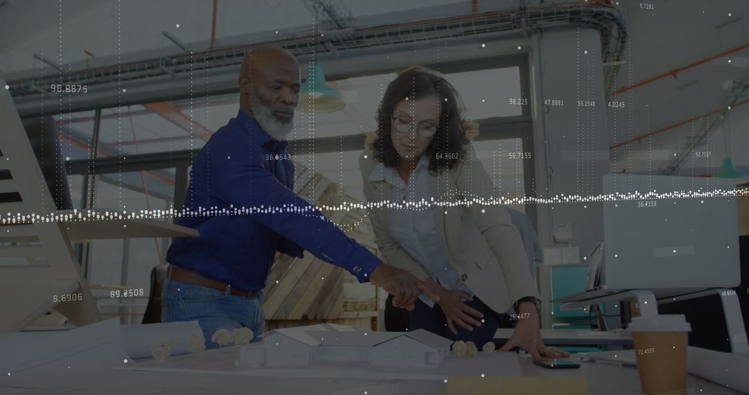 Multiracial Architects Analyzing Model with Digital Data Overlay