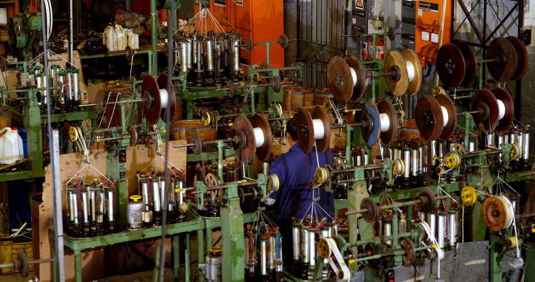 Industrial Factory Manufacturing Assembly Line with Worker Amidst Machinery - Free Images, Stock Photos and Pictures on Pikwizard.com