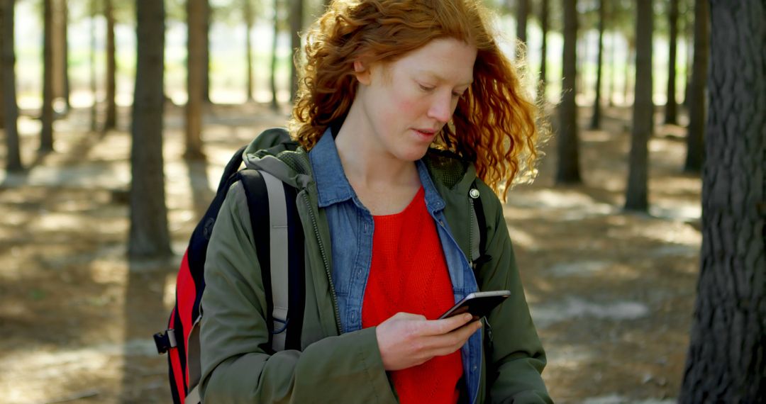 Woman Using Mobile Phone on Forest Adventure