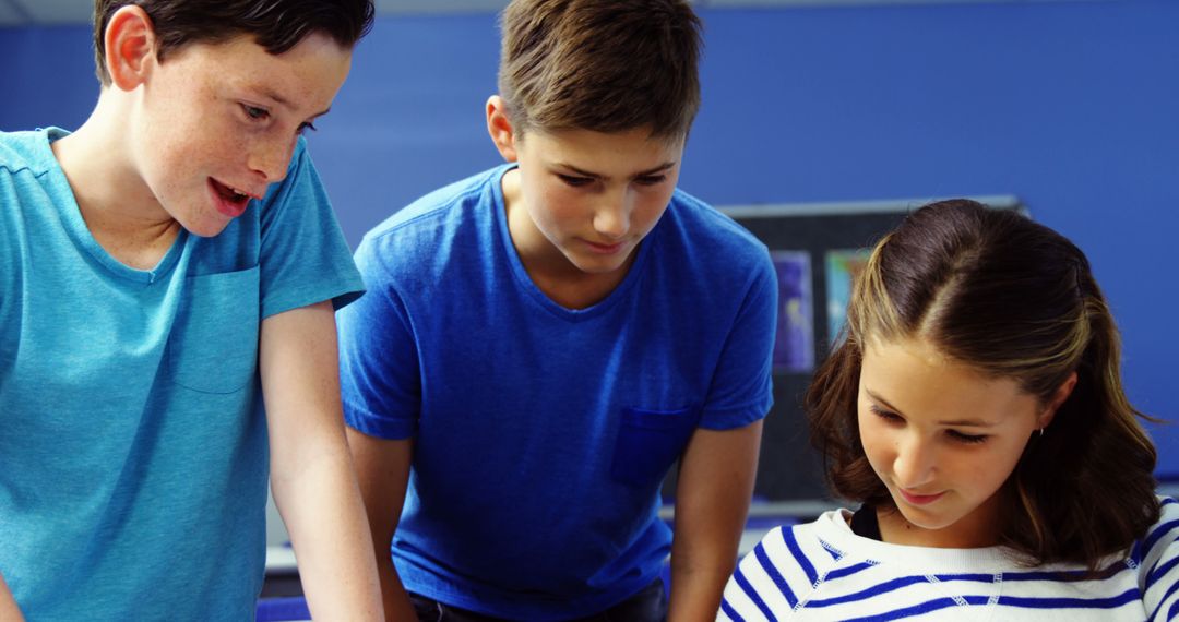 Students Collaborating with Tablet in Classroom Learning Environment