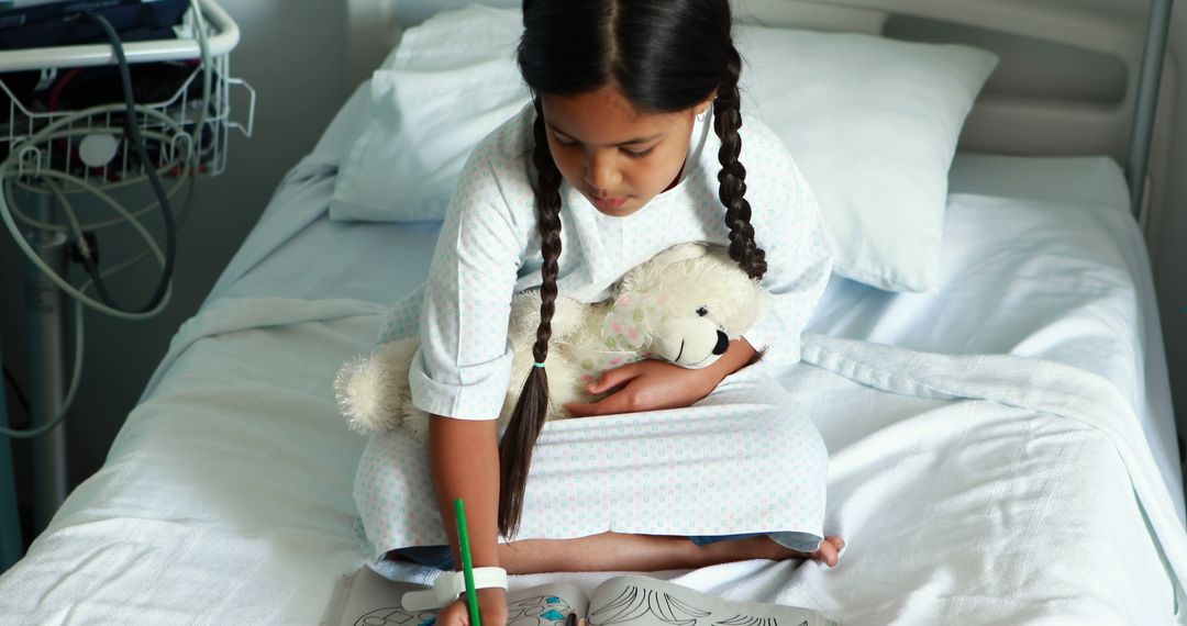 Young Girl in Hospital Bed Coloring with Stuffed Toy - Free Images, Stock Photos and Pictures on Pikwizard.com