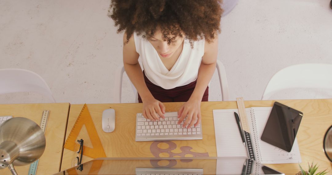 Top View of Young Woman Typing on Keyboard at Desk - Free Images, Stock Photos and Pictures on Pikwizard.com